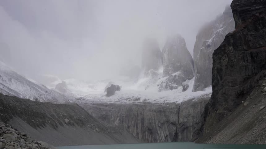 Fog is covering this mountain past the water
