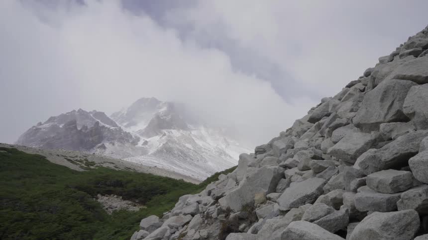 The hills are covered with rocks and snow