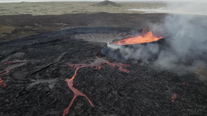 Volcano erupts lava amd smoke