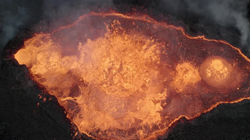 Aerial view of a volcano spewing lava during an eruption