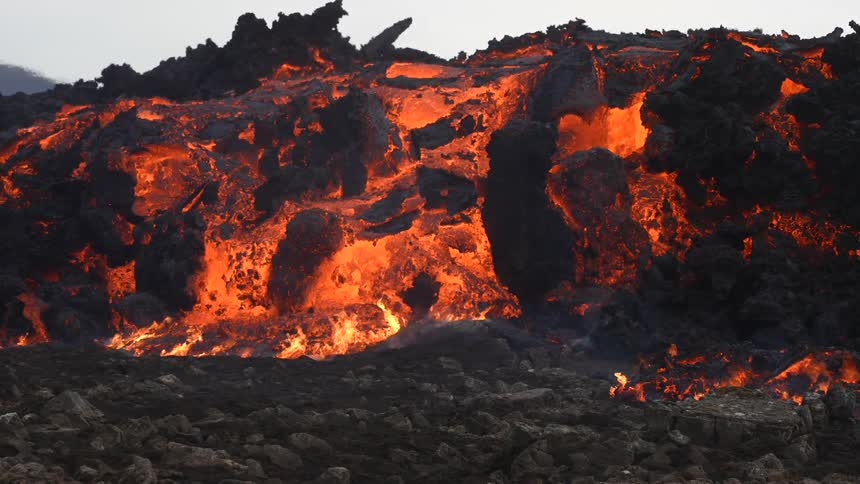 Fire and hot lava movement at the foot of an active volcano