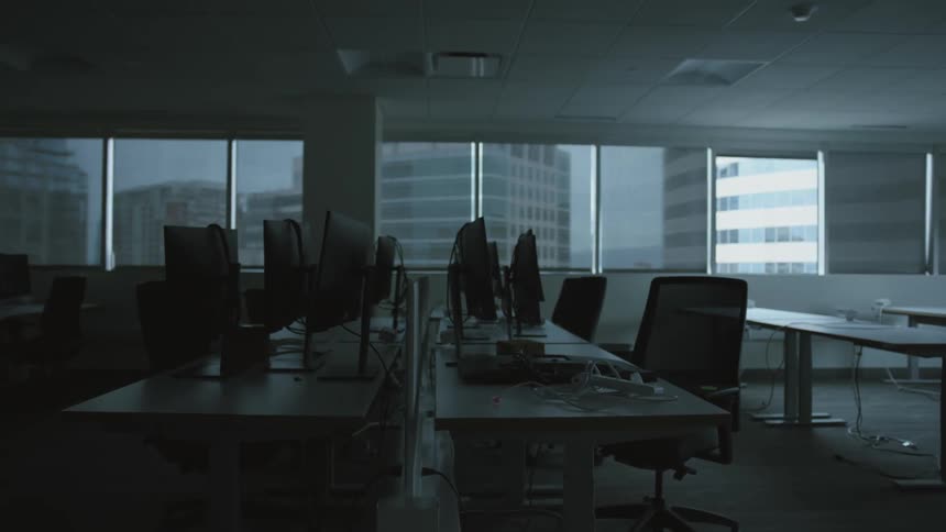 Computers desks and chairs in empty office