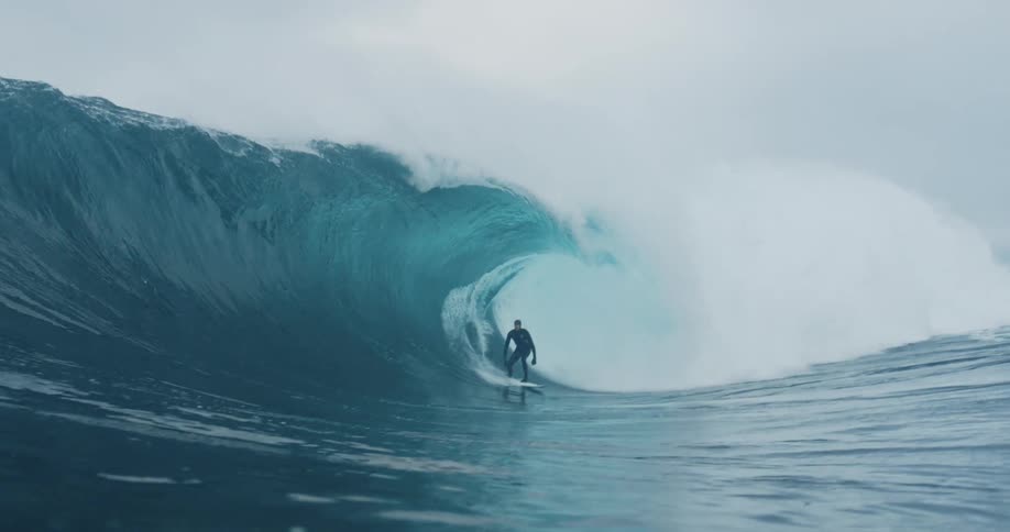Man surfing a massive wave
