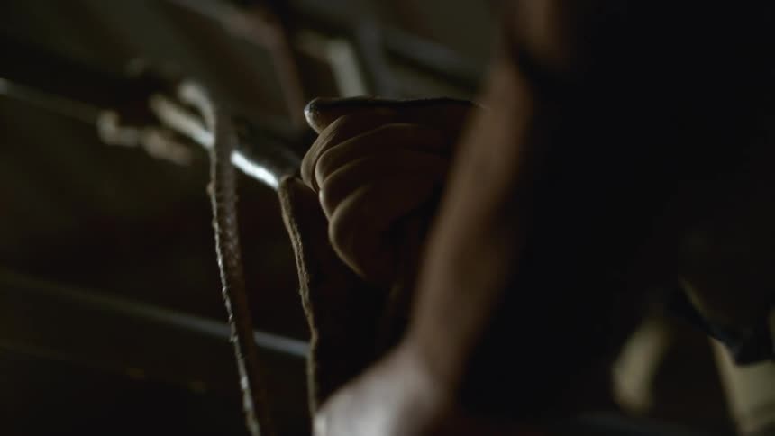 A person pulls on a strap