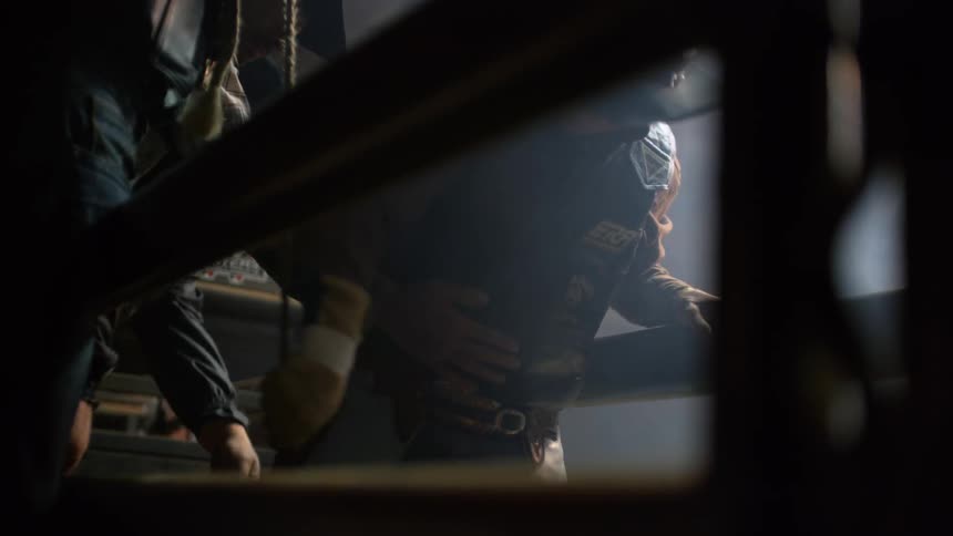 A man is pulling on some ropes