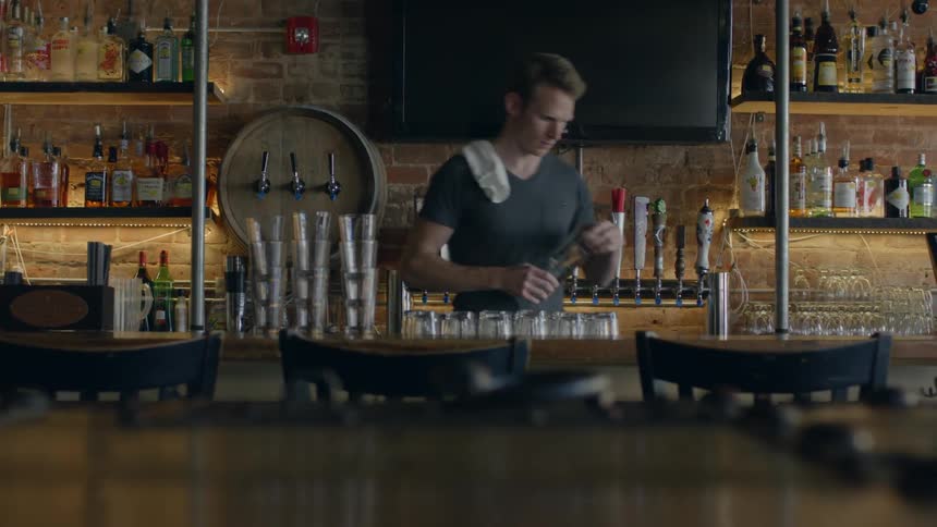 A bartender is setting up a bar