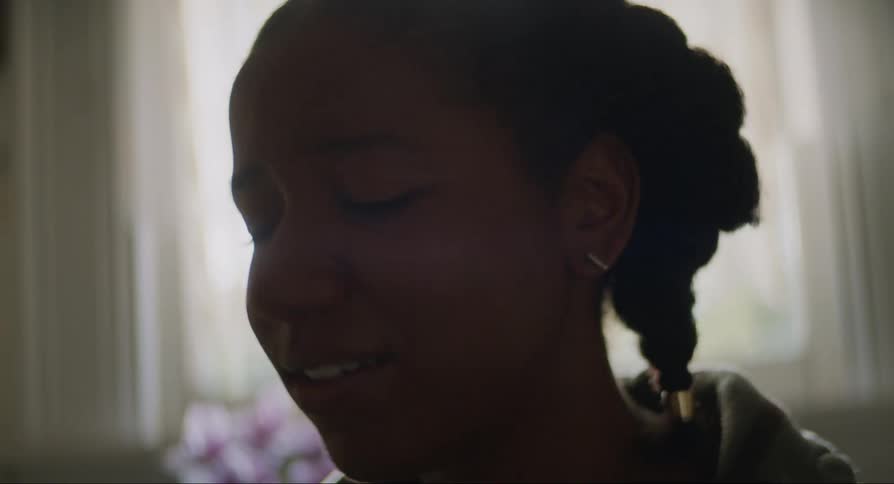 Young woman smiling and joyful while observing a pregnancy test