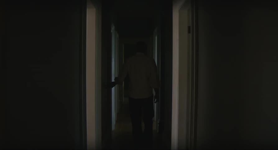 Male walking down dark hallway