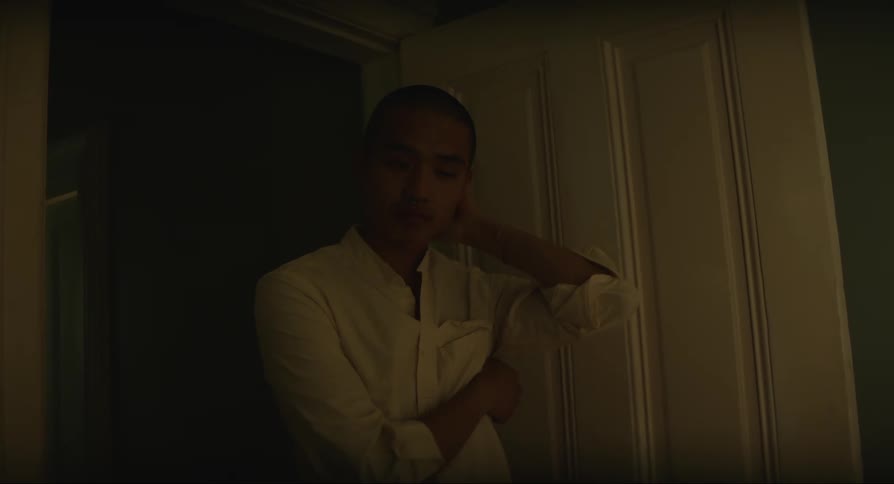 Man stands in doorway with contemplative look