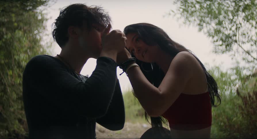 A guy and a girl lighting a cigarette