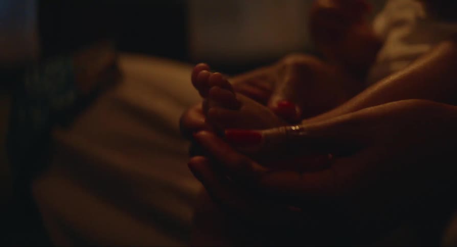 A person caresses a babys foot