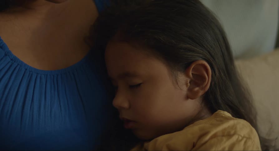 A child is sleeping in her mothers arms