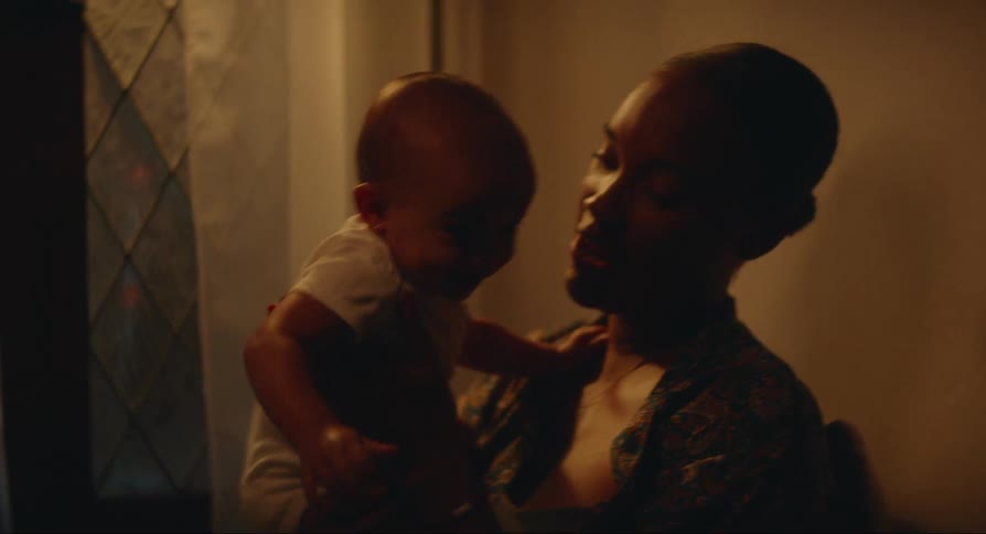 A mother is rocking her son