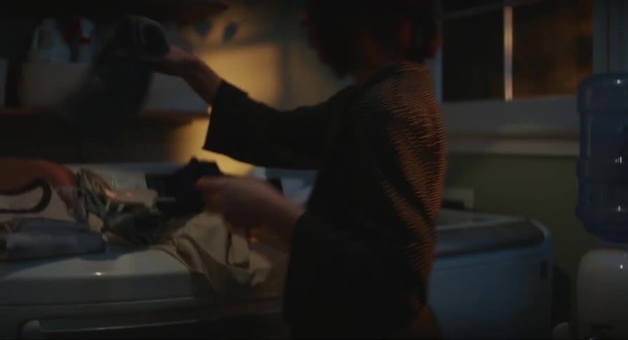 A woman does laundry at night