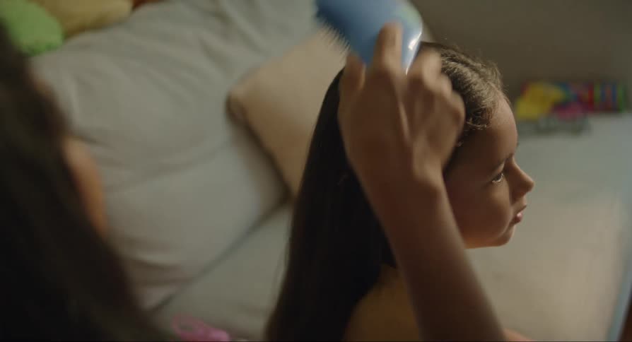 Mother combs daughters hair