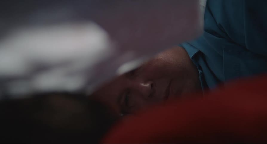 Father and son lying under the blanket talking