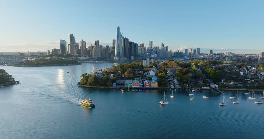 A boat sailing in a sea with habitable islands and in the background a huge city with tall buildings