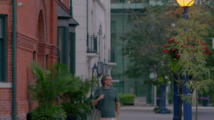 Man walking on the city looks both ways before crossing the street