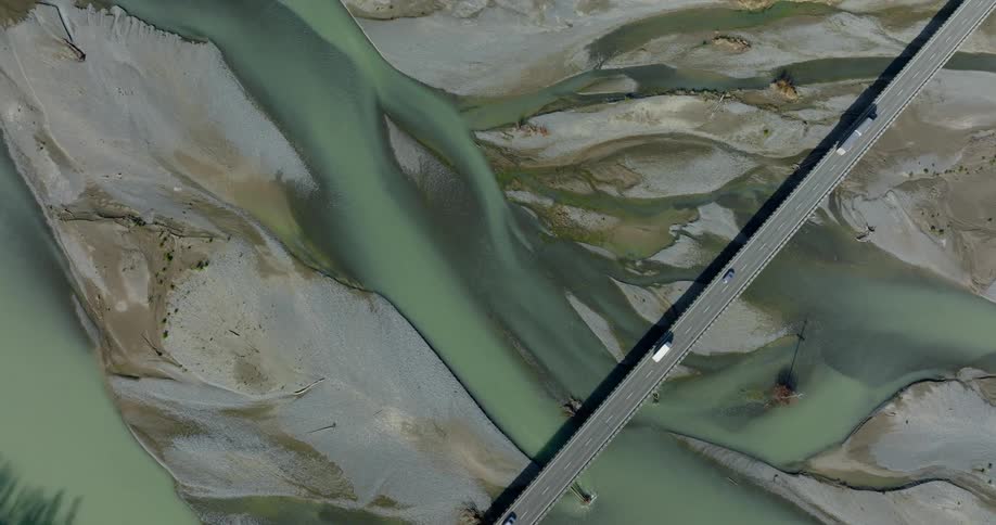 A huge bridge with a highway over a small river