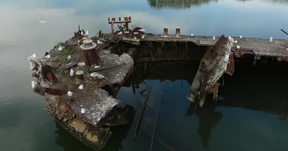 A ship wrecked in a river of dark waters