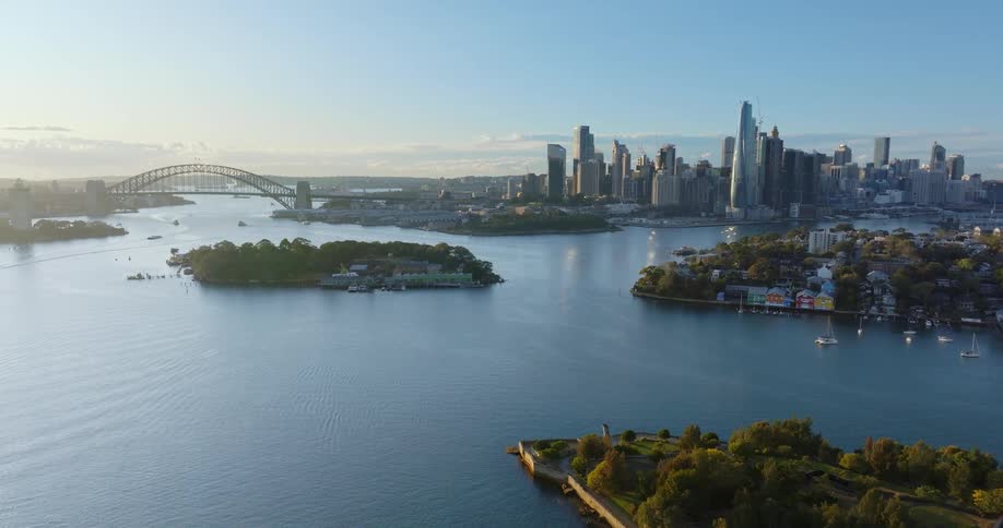 An aerial view of several lines in a sea and in the background there is a city with a big bridge
