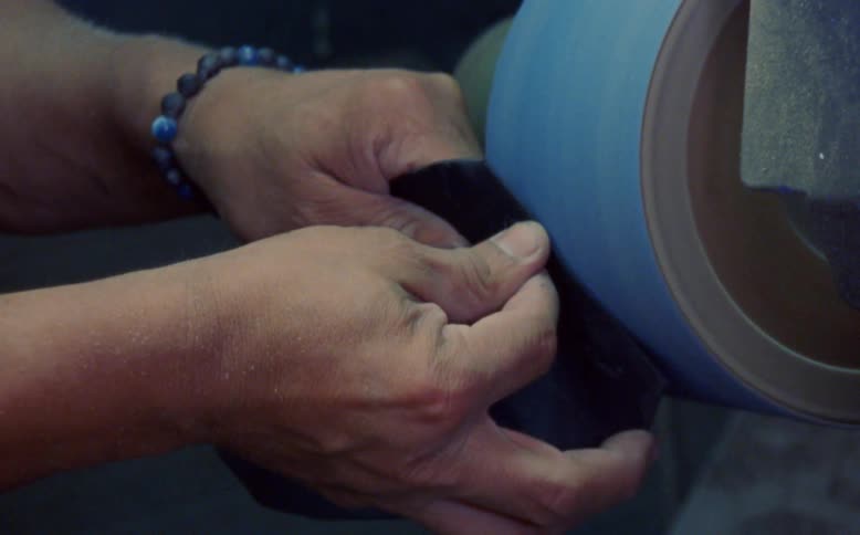A person is using a sanding machine