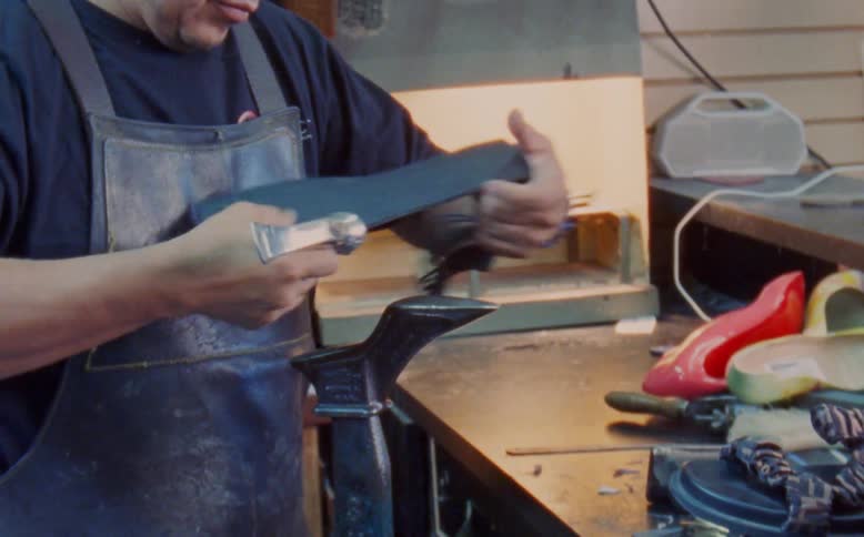 A shoemaker produces shoes in a factory