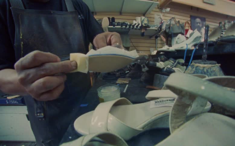 A worker is polishing the womens shoes in the store