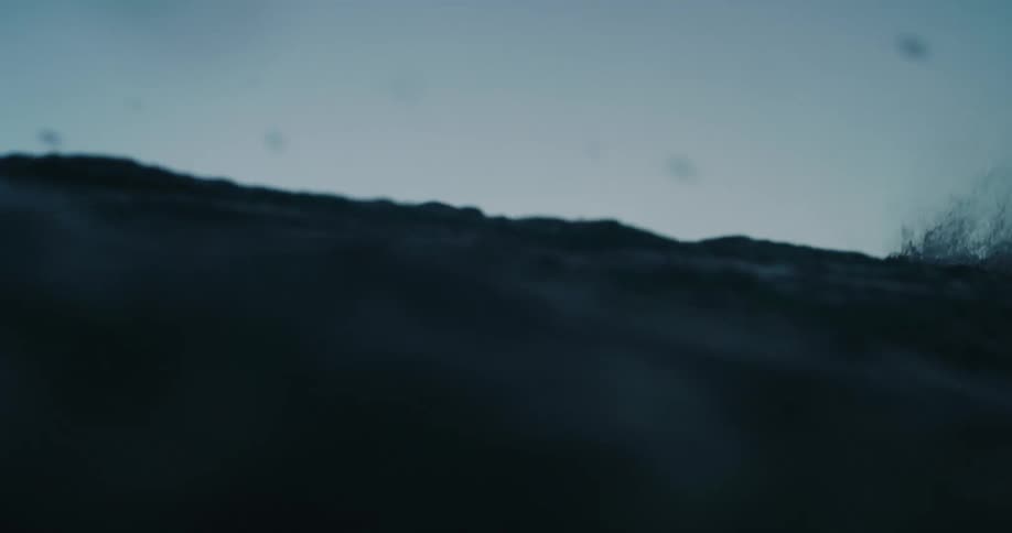 Ocean waves crash at dusk