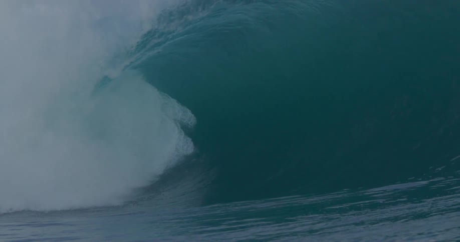 Huge ocean wave forming and breaking with tremendous force