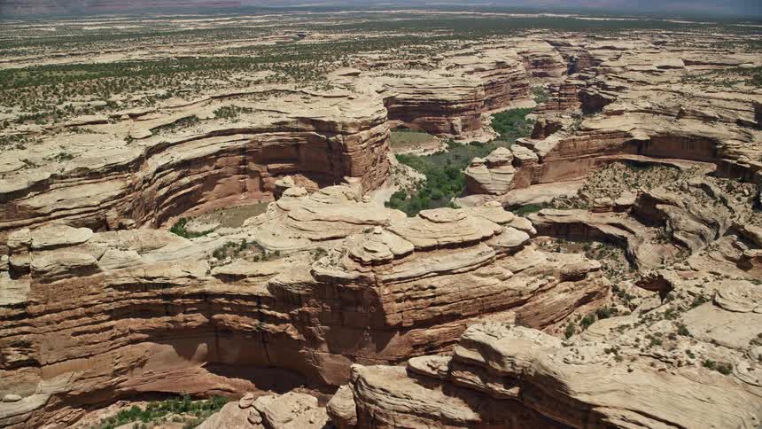 Aerial footage of Grand Gulch in Utah showcasing the deep canyon as the camera pans across the stunning landscape
