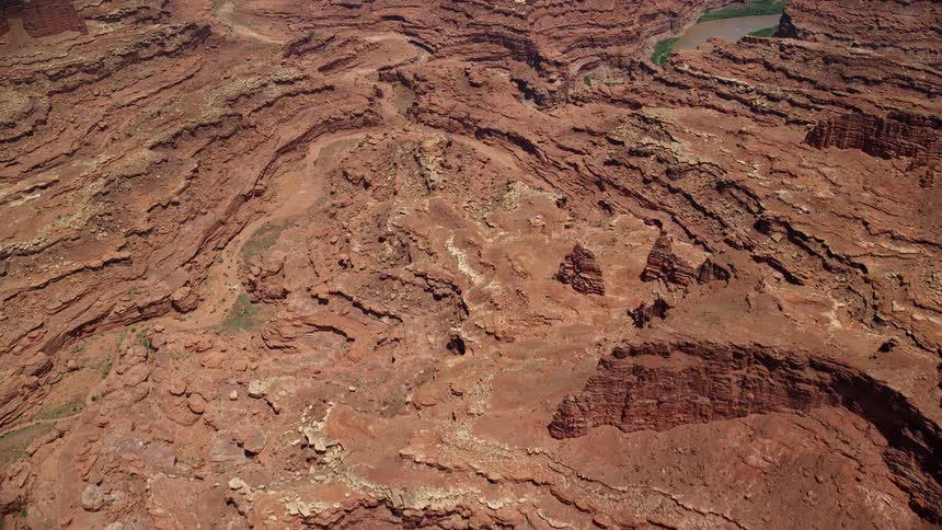 Bird's eye view of rugged canyons and buttes in Canyonlands National Park Utah capturing the stunning landscape and natural beauty during a sunny day