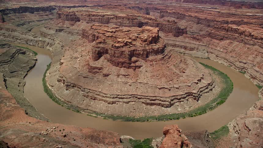 Aerial footage of the Colorado River winding through Meander Canyon in Canyonlands National Park Utah