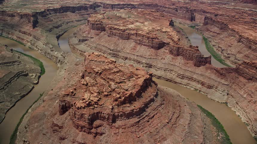 Aerial footage of flying toward the Colorado River and butte in Meander Canyon Canyonlands National Park Utah showcasing the stunning beauty of the arid desert landscape and famous canyon