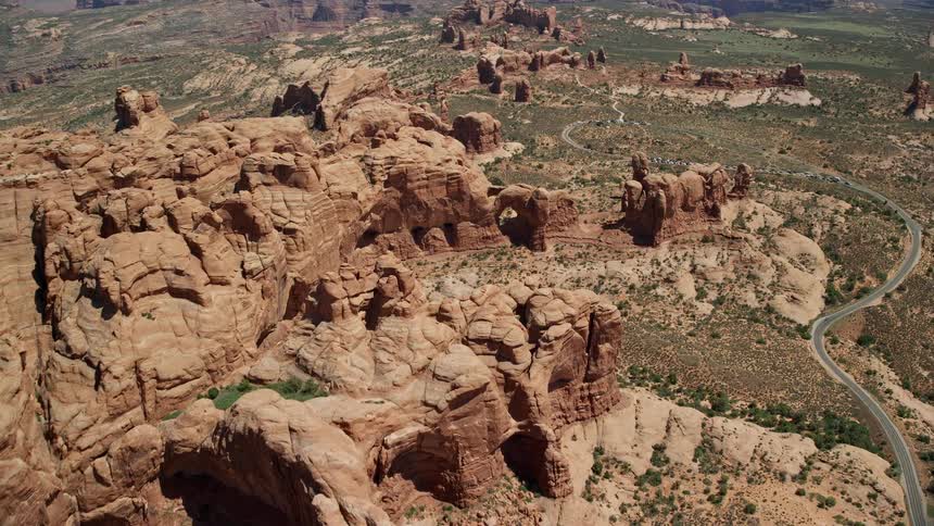 Aerial flyover and tilt to Elephant Butte and Double Arch in Arches National Park Utah highlighting the famous rock formations and scenic views from above