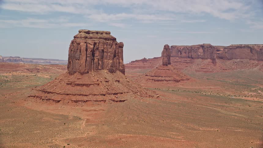  aerial footage of flying by Merrick Butte near West Mitten Butte capturing the mesmerizing desert landscape of Monument Valley Utah and Arizona with its famous natural landmarks and tribal lands