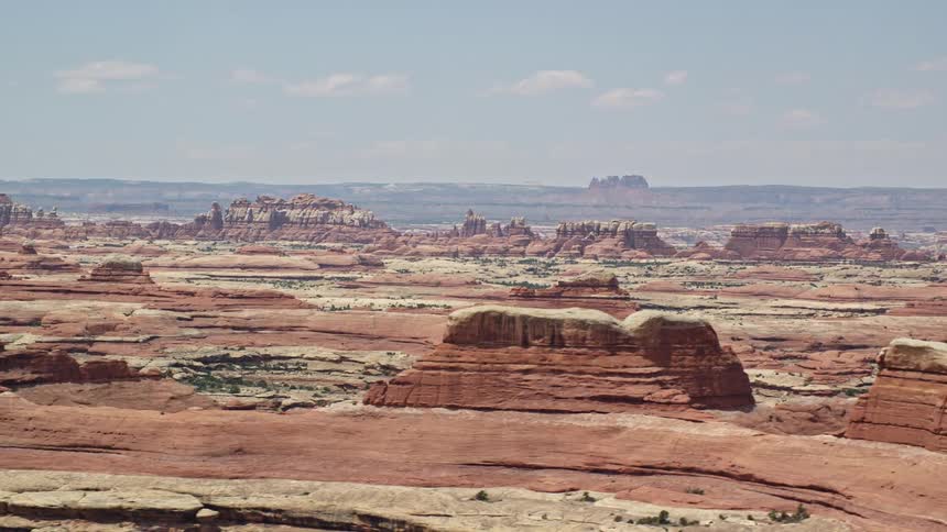 Aerial footage of flying by rock formations in Canyonlands National Park Utah showcasing the stunning desert landscape and famous red rock canyon walls