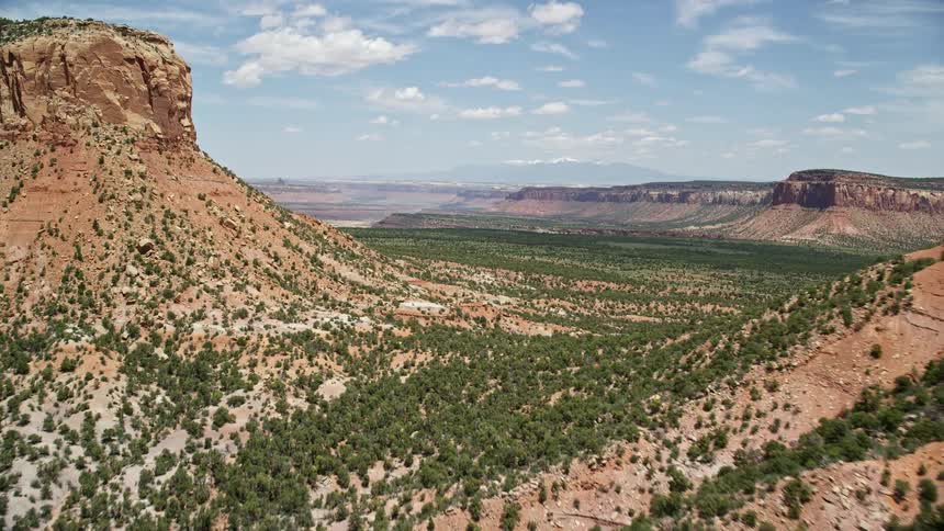  aerial footage of flying between Cathedral Butte and a mesa in Manti-La Sal National Forest Utah showcasing the stunning desert landscape and natural beauty of the Southwest United States