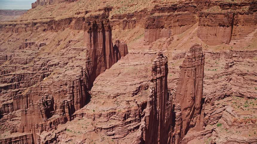  aerial footage of Cottontail and Echo Towers rock formations at Fisher Towers Utah showcasing the stunning natural landscape of mountains and canyons during a sunny day in the Southwest United States