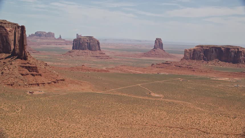 Aerial footage of buttes in Monument Valley Utah and Arizona showcasing the stunning desert landscape and Native American landmarks