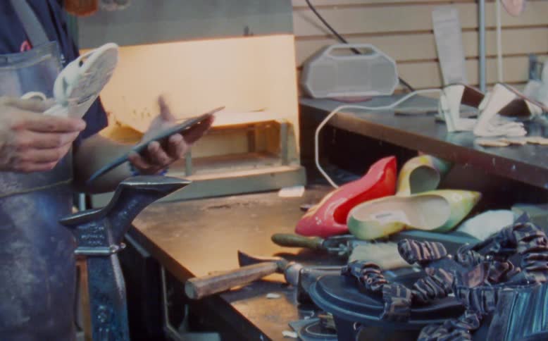 Man performing manufacturing work with sandals and high heels