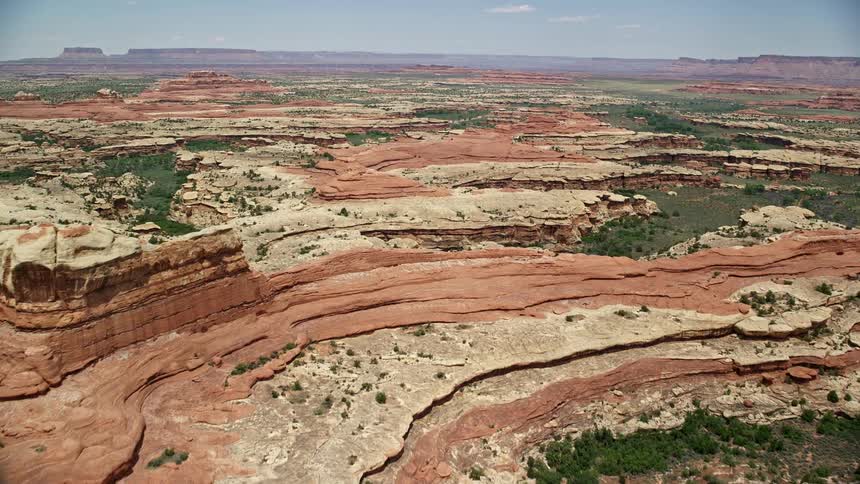  aerial footage exploring the stunning rock formations and canyons of Canyonlands National Park in Utah on a sunny day