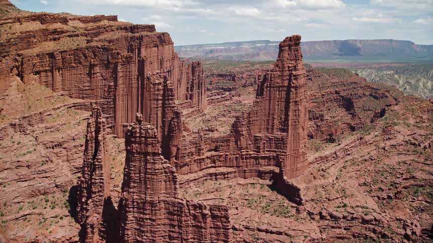 Approaching The Titan rock formation at Fisher Towers Utah during a sunny day capturing the arid desert landscape and breathtaking rock formations