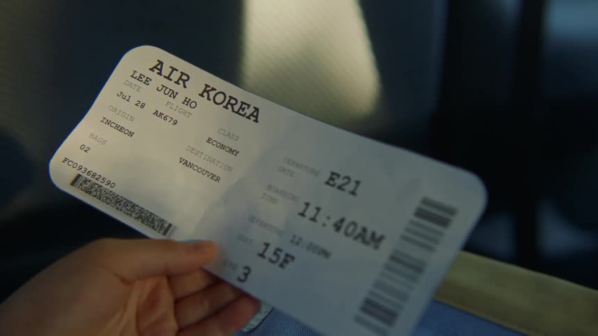 Person holds boarding pass ticket