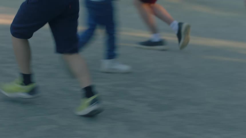 Legs of children running in an open space