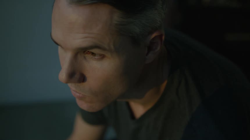 A man is leaning forward
