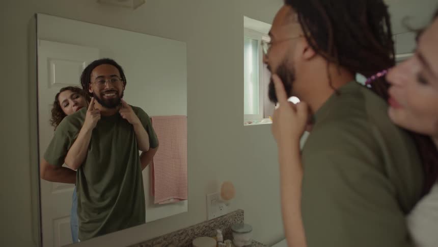 Couple dancing in front of the bathroom mirror