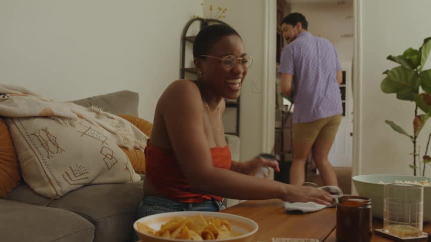 A man and woman are cleaning at home