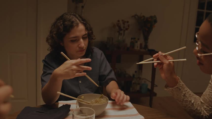 Three people are having dinner together