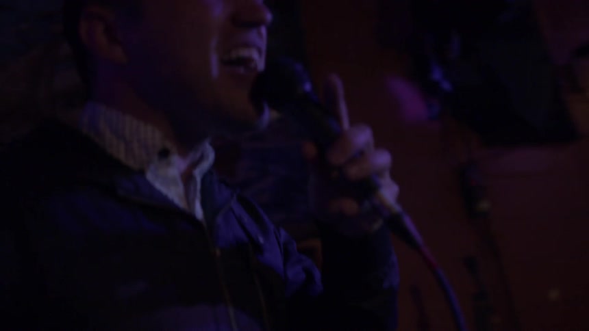 Man sings on stage at night